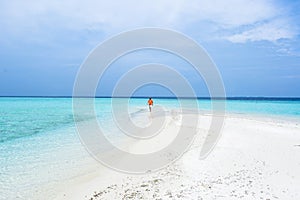 A boy and Umbrella on the beach of Maldives