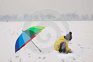 Boy with umbrella in snowy Summer Palace
