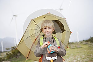 Boy With Umbrella At Wind Farm