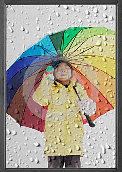 Boy with umbrella in winter rain