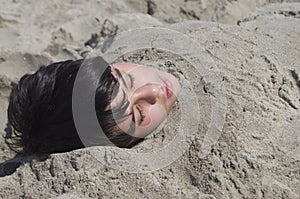 Boy under Sand