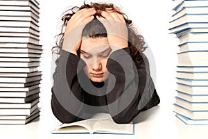 Boy unhappy and many books