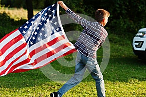 Boy with USA flag outdoor. America celebrating
