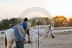 Boy using a ball during an equine therapy session