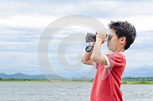 Boy using binoculars near