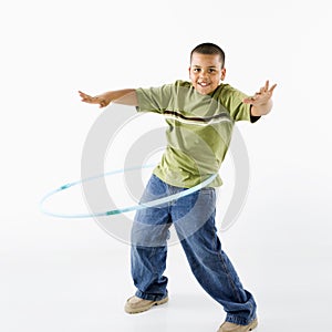 Boy using hula hoop.