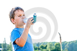 Boy using inhaler for asthma