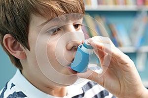 Boy Using Inhaler To Treat Asthma Attack