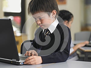 Boy Using Laptop In Class