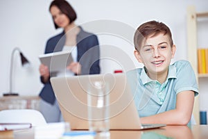 Boy using laptop at home