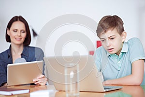 Boy using laptop at home