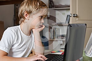 Boy using laptop home