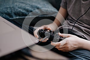 The boy using a laptop for playing online games.