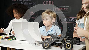 Boy using laptop programing engineering code and writing program. Erudition.
