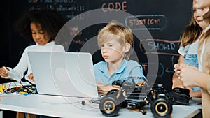 Boy using laptop programing engineering code and writing program. Erudition.