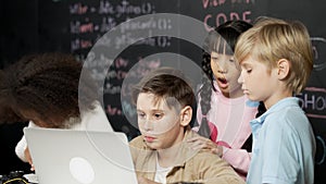 Boy using laptop programing engineering code and writing program. Erudition. photo