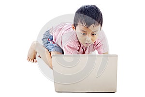 Boy using laptop seriously