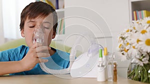 Boy using nebuliser inhaler - allergy and asthma concept