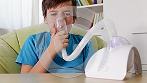 Boy using nebuliser inhaler - coughing