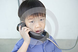 Boy using public phone