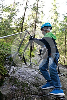 Boy using safety climbing equipment