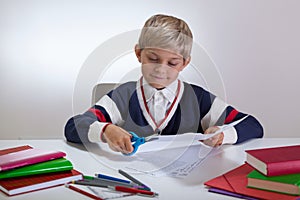 Boy using scissors on the desk