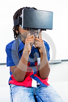 Boy using virtual reality headset in classroom