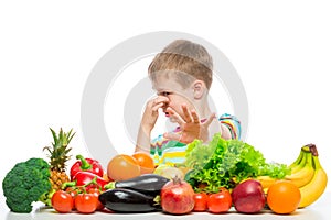 Boy and vegetables, unloved food concept