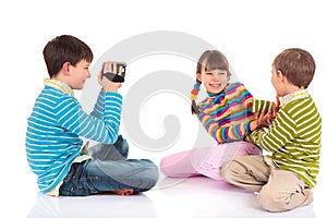 Boy videotaping kids playing