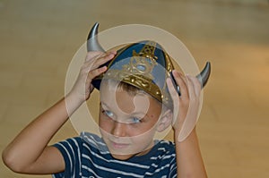 Boy in the viking helmet looking aside