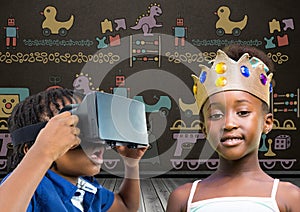 Boy with VR Headset and girl with crown in front of blackboard with toys graphics