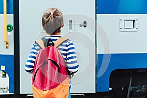 Boy waiting for express train on railway station platform. Kid with backpack on a subway