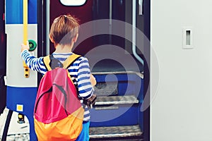 Boy waiting for express train on railway station platform. Kid with backpack on a subway