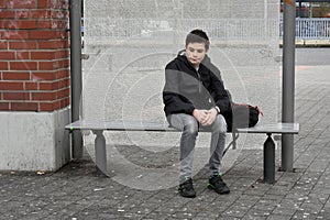 Boy waiting at school bus stop