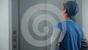 Boy waits for an elevator shot from behind