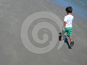 Boy walking on beach