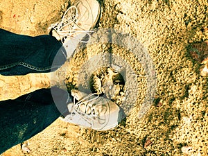 Boy walking on desert close up