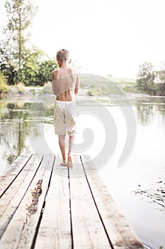 Boy walking on dock