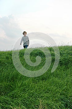 Boy Walking on Hill