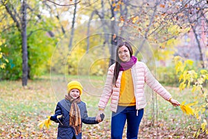 Boy walking with his mother in autumn park