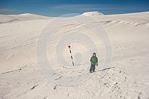 Boy walking on a marked path on the mountain photo
