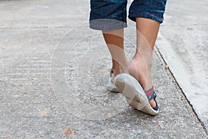 The boy walking on the road with sandals shoes . Step walk concept