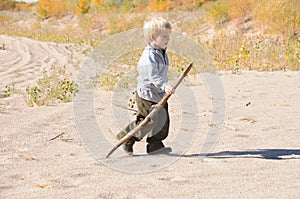 Boy walking on sand dunes