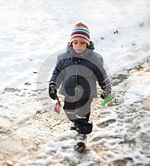 Boy walking in snow