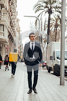 Boy walking in town with suit