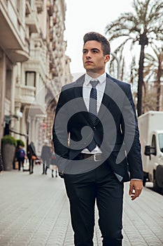 Boy walking in town with suit