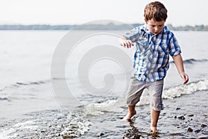 Boy walking in water