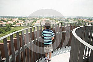 Boy walking on the wood bridge city park