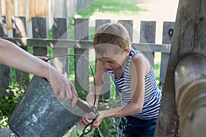Boy washes well water.