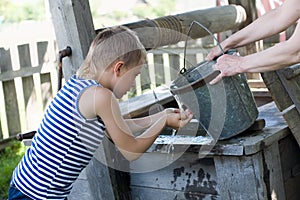 Boy washes well water.